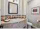 Well-appointed powder room with elegant fixtures, stylish decor, and a clean, modern design at 35 Brookhaven Pl, Littleton, CO 80123