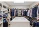 Well-organized walk-in closet with shelving and storage for clothing and accessories at 35 Brookhaven Pl, Littleton, CO 80123