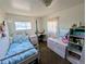 Bright bedroom with a charming bed frame and lots of natural light at 6710 Clermont St, Commerce City, CO 80022