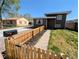 Charming two-story home with a well-maintained front yard and picket fence at 6710 Clermont St, Commerce City, CO 80022