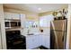 Well-equipped kitchen with white cabinets, stainless steel appliances, and a garden window at 6710 Clermont St, Commerce City, CO 80022