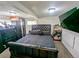 Main bedroom in basement area with low ceilings and egress window at 6710 Clermont St, Commerce City, CO 80022