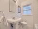 Charming bathroom with classic fixtures, a pedestal sink, and subway tile at 5703 Ammons St, Arvada, CO 80002