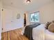 Serene bedroom with hardwood floors, closet space, and a large window for natural light at 5703 Ammons St, Arvada, CO 80002