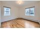 Bedroom featuring hardwood floors and updated windows at 5703 Ammons St, Arvada, CO 80002