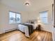 Comfortable bedroom with hardwood floors, lots of natural light, and a cozy atmosphere at 5703 Ammons St, Arvada, CO 80002