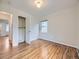 Bright bedroom with hardwood floors, closet, and large window at 5703 Ammons St, Arvada, CO 80002