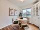 Cozy dining area features a round table with seating for four, natural light, and stylish decor at 5703 Ammons St, Arvada, CO 80002