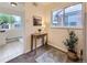 Entryway featuring a small table, artwork, and access to sunroom at 5703 Ammons St, Arvada, CO 80002