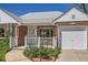Charming brick home featuring a well-manicured front yard and a cozy front porch area at 5703 Ammons St, Arvada, CO 80002