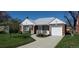 Charming red brick house with a well-manicured lawn and welcoming front porch at 5703 Ammons St, Arvada, CO 80002
