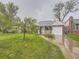 Quaint red brick house with a well-maintained lawn and inviting curb appeal at 5703 Ammons St, Arvada, CO 80002