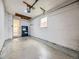 Spacious unfinished garage with storage shelving, natural light, and access to the home's interior at 5703 Ammons St, Arvada, CO 80002