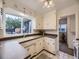 Classic kitchen with white cabinets, a double basin sink, and plenty of natural light at 5703 Ammons St, Arvada, CO 80002