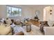 Bright living room with hardwood floors, large window, and stylish furniture arrangement at 5703 Ammons St, Arvada, CO 80002