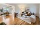 Bright living room featuring hardwood floors, a comfortable sofa, and stylish decor at 5703 Ammons St, Arvada, CO 80002