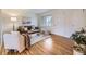 Bright living room with hardwood floors, neutral walls, comfortable seating, and natural light at 5703 Ammons St, Arvada, CO 80002