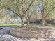 A serene park with a stone-lined circle featuring trees in full bloom, creating a peaceful ambiance at 5703 Ammons St, Arvada, CO 80002