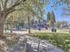 A colorful playground with slides and swings surrounded by trees on a sunny day at 5703 Ammons St, Arvada, CO 80002