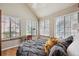 Light-filled bedroom featuring hardwood floors, multiple windows, and a cozy atmosphere at 840 S Vance St # A, Lakewood, CO 80226