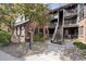 Exterior view of a brick apartment building with mature trees and well-maintained landscaping at 840 S Vance St # A, Lakewood, CO 80226