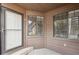 Inviting front door with storm door, windows, and wood siding for a cozy, well-lit entrance at 840 S Vance St # A, Lakewood, CO 80226