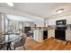 Open floor plan showcasing the kitchen, dining area, and living room with a cozy fireplace at 840 S Vance St # A, Lakewood, CO 80226
