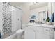 Well-lit bathroom featuring a tiled shower, modern vanity, and stylish fixtures at 8142 S Langdale Way, Aurora, CO 80016