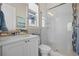 Modern bathroom with glass shower enclosure, white tiled walls, and neutral accents at 8142 S Langdale Way, Aurora, CO 80016