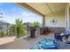Relaxing covered deck features a built-in stone grill and outdoor seating with a lovely view at 8142 S Langdale Way, Aurora, CO 80016