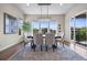 Elegant dining room with large windows, modern chandelier, and stylish decor at 8142 S Langdale Way, Aurora, CO 80016