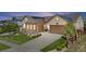 Inviting two-story home showcasing a well-manicured lawn, stone accents, and a two-car garage at 8142 S Langdale Way, Aurora, CO 80016