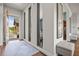 Stylish foyer with a modern design, featuring an open entrance and hardwood floors at 8142 S Langdale Way, Aurora, CO 80016