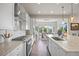 Bright kitchen featuring a large island, stainless steel appliances, and hardwood floors at 8142 S Langdale Way, Aurora, CO 80016