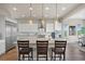 Modern kitchen island with granite countertops, pendant lighting, and seating at 8142 S Langdale Way, Aurora, CO 80016