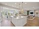 Bright, open kitchen with a large island, stainless steel appliances, and seamless access to the living area at 8142 S Langdale Way, Aurora, CO 80016
