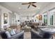 Open-concept living room seamlessly connecting to the kitchen with modern finishes and ample space at 8142 S Langdale Way, Aurora, CO 80016