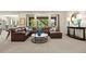 Spacious living room featuring a comfortable leather sectional and abundant natural light from multiple windows at 8142 S Langdale Way, Aurora, CO 80016