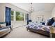Bright bedroom with a large window, stylish decor, and comfortable seating area at 8142 S Langdale Way, Aurora, CO 80016