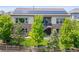 Beautiful two-story home with a stone and siding exterior, solar panels, and backyard patio at 8142 S Langdale Way, Aurora, CO 80016
