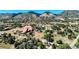 Panoramic aerial view showcases a picturesque neighborhood nestled among rolling hills and lush greenery at 5799 Crestbrook Cir, Morrison, CO 80465