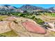 Aerial view of an equestrian arena showing riding space, horse facilities and mountain views at 5799 Crestbrook Cir, Morrison, CO 80465