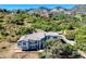 A home with a tile roof sits amidst lush greenery, showcasing the property's serene and secluded setting at 5799 Crestbrook Cir, Morrison, CO 80465