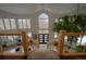 The stunning foyer features a grand staircase, a soaring ceiling, and an indoor tree at 5799 Crestbrook Cir, Morrison, CO 80465