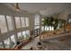 The bright foyer features a soaring ceiling, an indoor tree, and picture windows with seating at 5799 Crestbrook Cir, Morrison, CO 80465