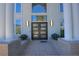 A close up shot of the home's entry with stylish double doors framed by columns and manicured flower beds at 5799 Crestbrook Cir, Morrison, CO 80465