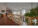 Bright hallway with a wooden railing, large windows, and stylish decor at 5799 Crestbrook Cir, Morrison, CO 80465