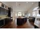 Bright kitchen with large windows, an island, sleek countertops, and dark cabinetry at 5799 Crestbrook Cir, Morrison, CO 80465