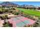 Aerial view of tennis courts, golf course, and playground, showcasing the community's recreational amenities at 5799 Crestbrook Cir, Morrison, CO 80465