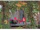 Cozy backyard patio with pergola, stone exterior, colorful flowers, and comfortable outdoor seating at 1423 E Fair Pl, Centennial, CO 80121
